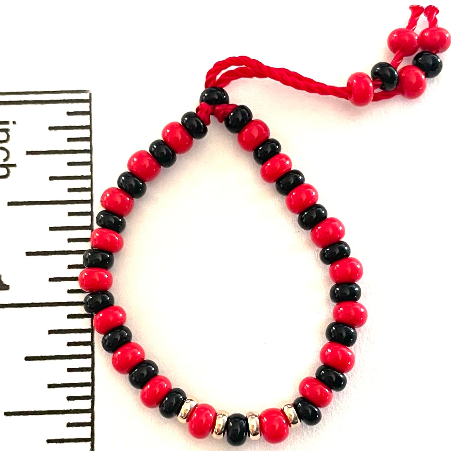 Red bracelet for sales baby meaning